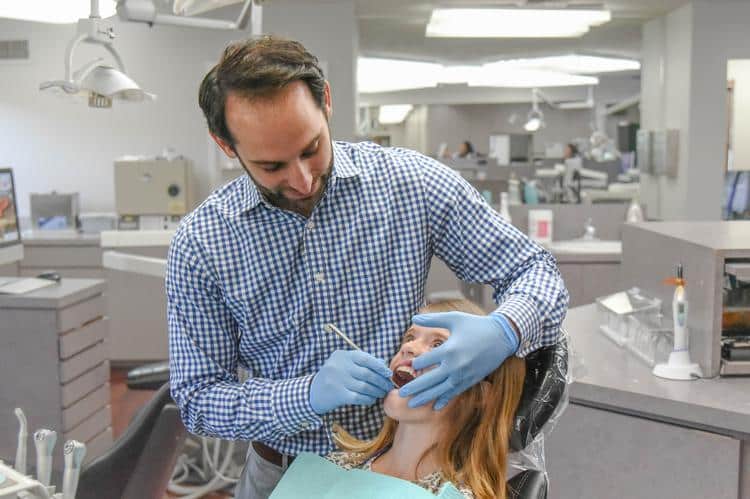 Adolscent-care-smile-experience-orthodontics Early orthodontic care patient with dr. Rosenberg in chair