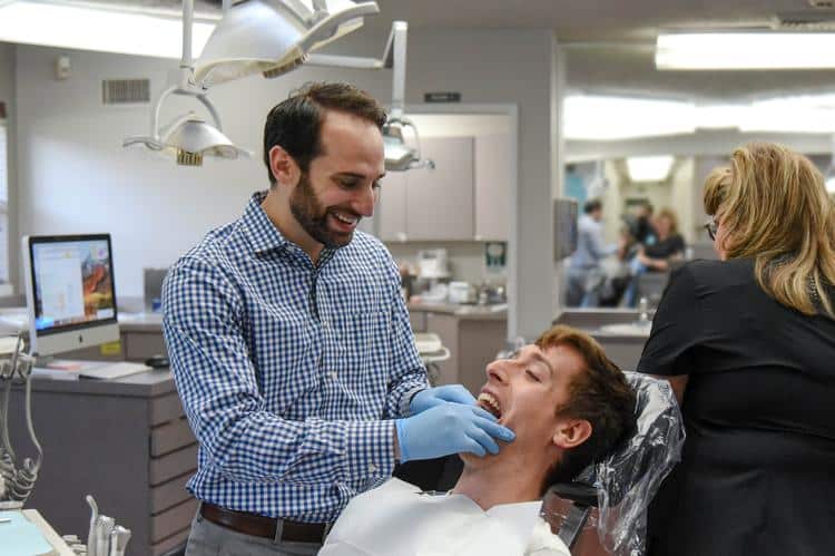 Dr-rosenberg-orthodontic-care-smiling-teenage-patient Teenage orthodontic patient smiling with dr. Rosenberg