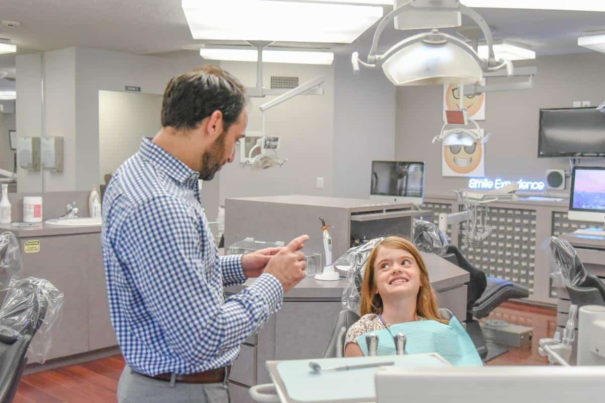 Dr. Rosenberg educating orthodontic patient retainer instructions