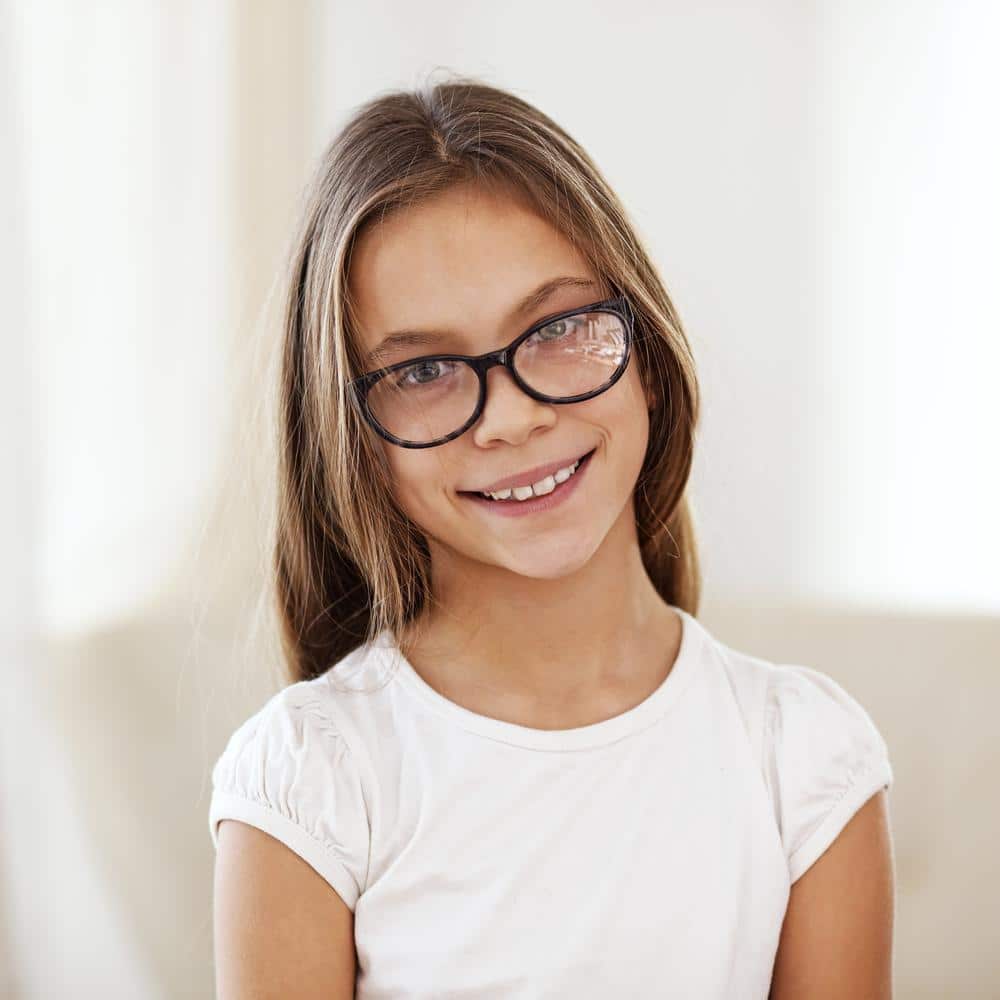 pre teen girl with glasses smiling