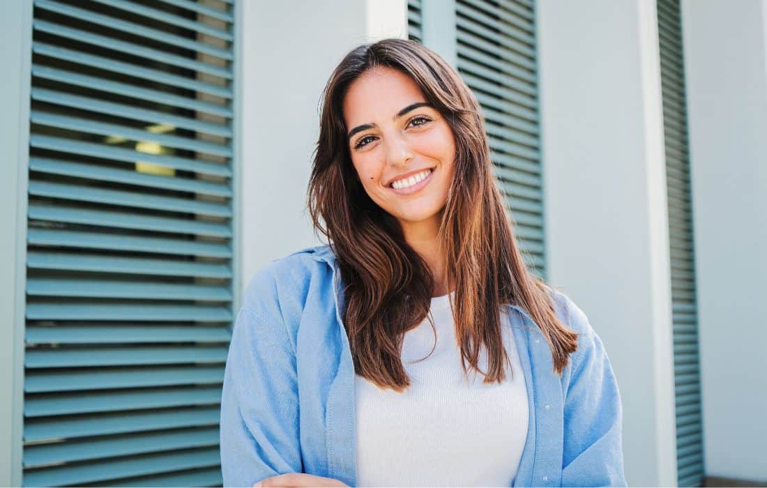 Smiling-woman-outside-straight-teeth Young woman straight teeth beautiful smile outside