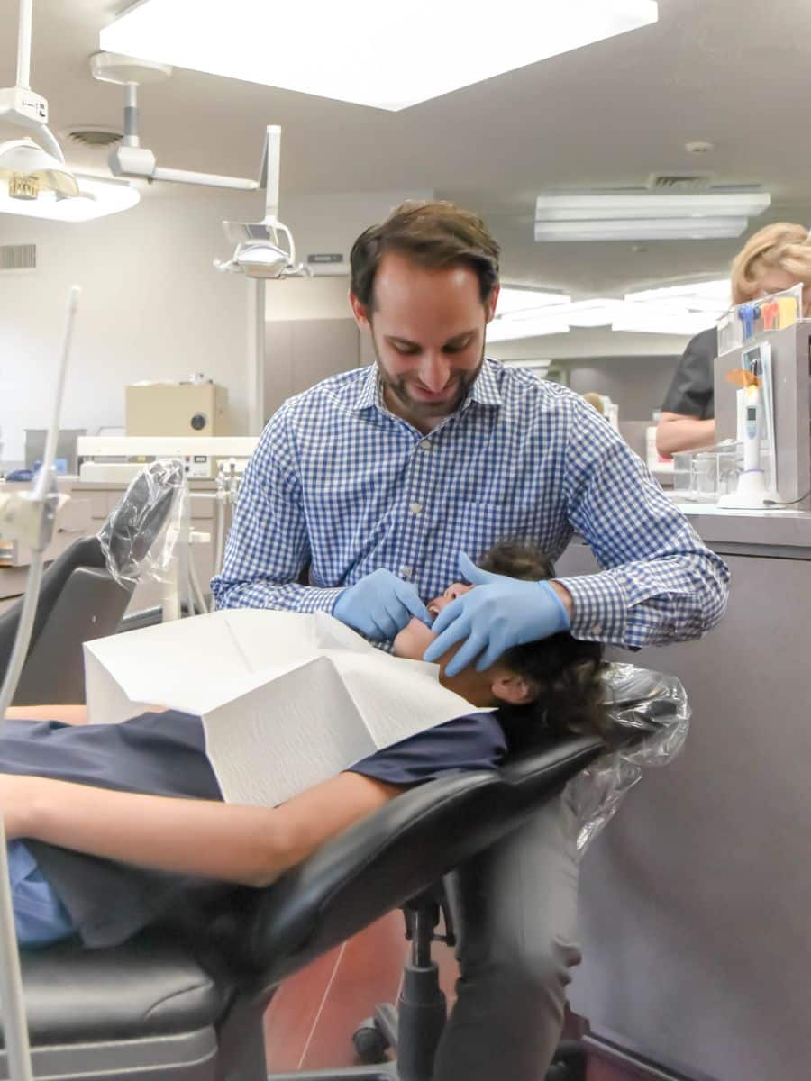 Smile-experience-orthodontics-dr-rosenberg-with-patient Dr rosenberg examining patient smile experience orthodontics