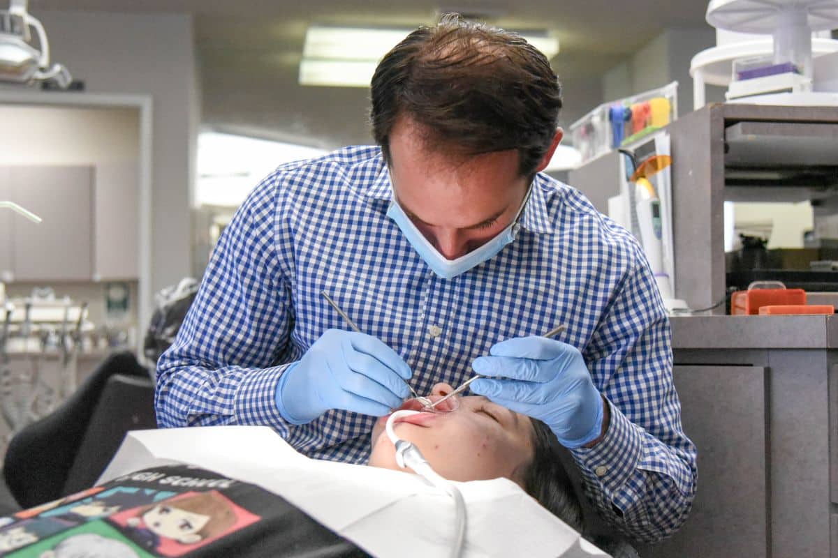 Smile-experience-livingston-orthodontics Dr. Rosenberg working with a patient at smile experience orthodontics in livingston during an orthodontic appointment