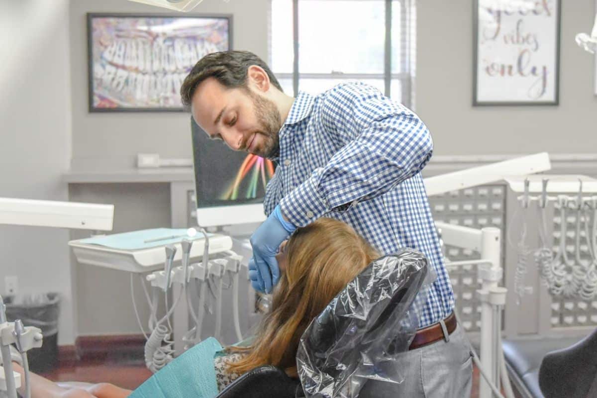 Smile-experience-orthodontics-services-near-hanover Orthodontic dentist discussing invisalign and clear ceramic braces with a patient using a digital screen at smiles orthodontics near hanover
